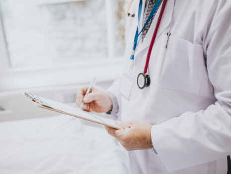 Physician noting down symptoms of a patient